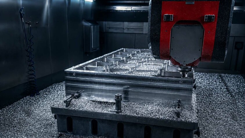 CNC-Fräsmaschine bei der präzisen Aluminiumbearbeitung eines großformatigen Werkstücks im Werkzeugbau.
