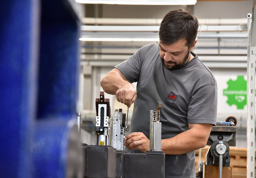 Jobs in Steyr bei weba Werkzeugbau für Berufserfahrene und Profis Ein Metalltechniker bei weba Werkzeugbau in Aktion, konzentriert auf den Zusammenbau von Messaufnahmen in der Produktionshalle. Der Techniker, in sauberer und praktischer Arbeitskleidung, arbeitet präzise an einem gut beleuchteten Arbeitstisch. Umgeben von verschiedenen Werkzeugen und Bauteilen, zeigt das Bild den Detailreichtum und die Präzision, die im Werkzeugbau erforderlich sind. Die Szene vermittelt ein Gefühl von Fachwissen und Engagement im Produktionsprozess, charakteristisch für die hohe Qualitätsstandards bei weba. Das Bild steht symbolisch für Jobs in Steyr für Berufserfahrene und Profis bei weba Werkzeugbau.