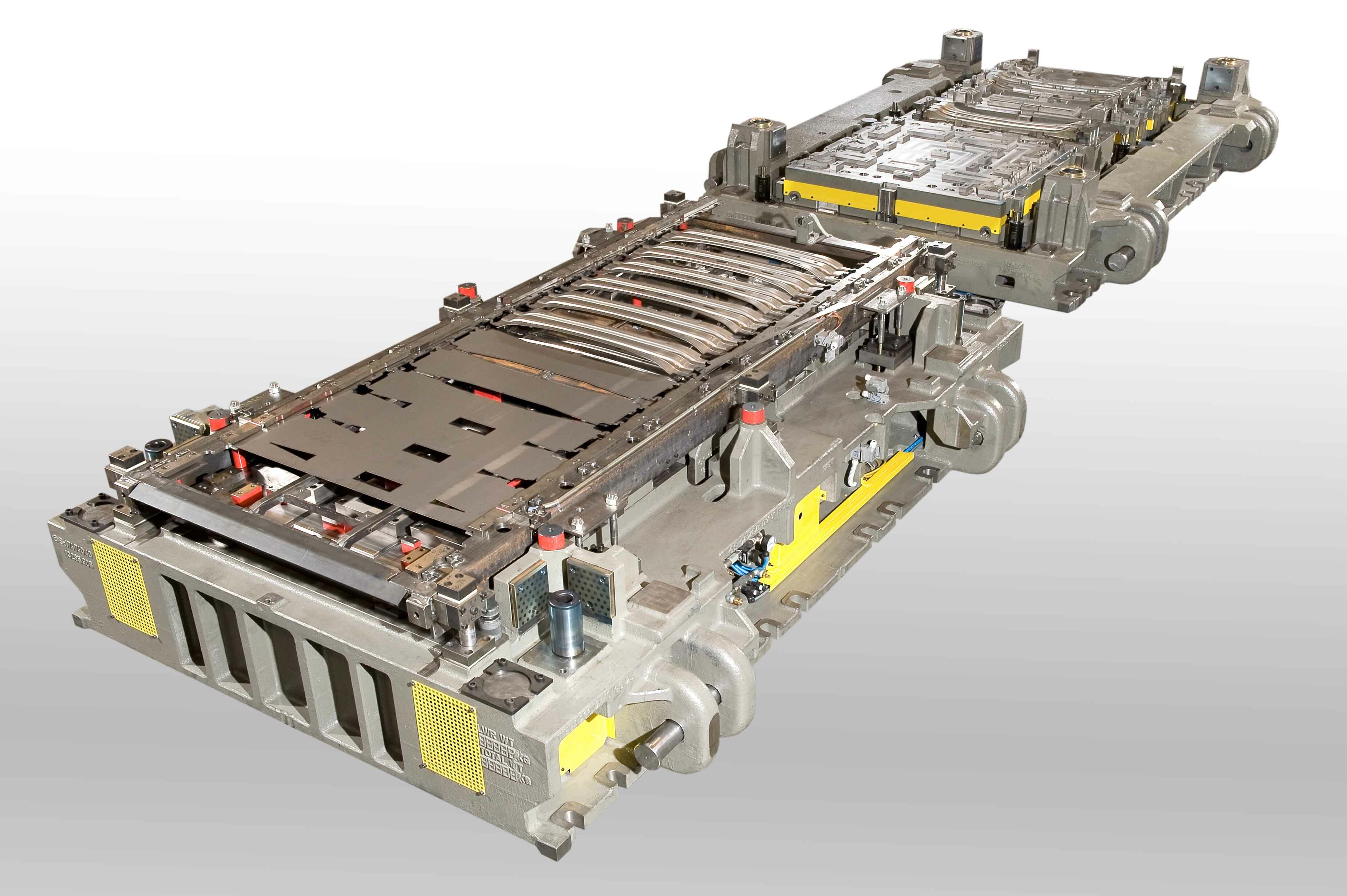 Progressive die for cold forming: complex tooling system with multiple forming and cutting stages for series production of sheet metal components.