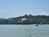 View across Kunming Lake toward the Summer Palace in Beijing, surrounded by green hills and boats on the water – one of Jan Wengryn’s travel impressions.