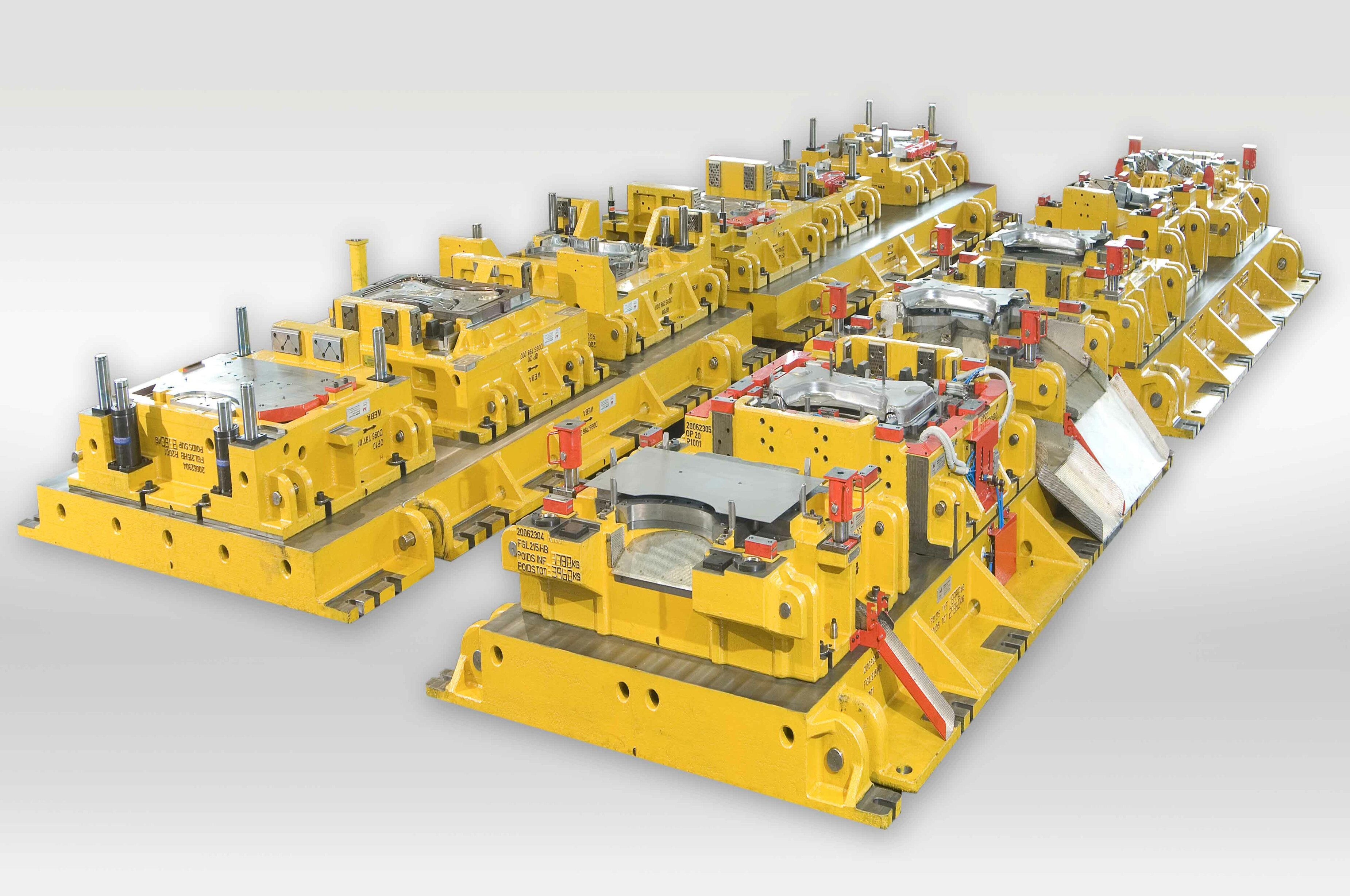 Transfer die set for cold forming: multiple sequential tool stations for shaping complex sheet metal parts in automotive production.