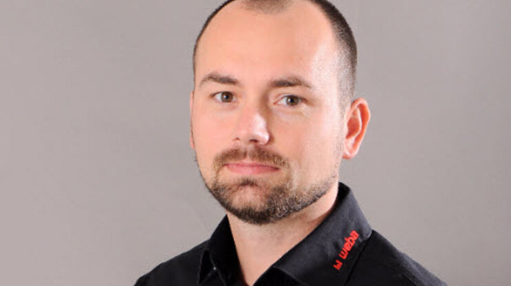 Portrait of Radek Šimek, Project Manager at Weba Werkzeugbau, wearing a black company shirt against a neutral background.