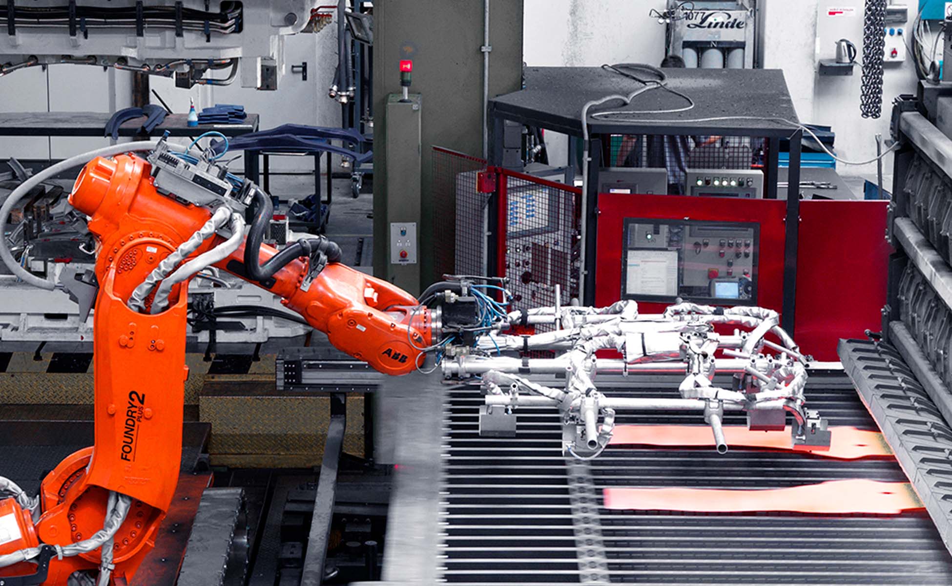 weba Werkzeugbau - Platinentransfer in der Warmumformung Roboter-Arm entnimmt zwei glühende Formplatinen für den Transfer in die Warmumformpresse